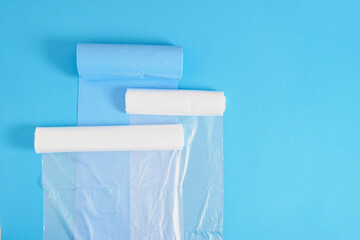 different plastic polyethylene trash bag rolls on blue background