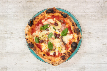 Italian handmade fresh pizza on wooden table high angle view