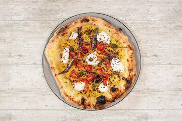Italian handmade fresh pizza on wooden table high angle view