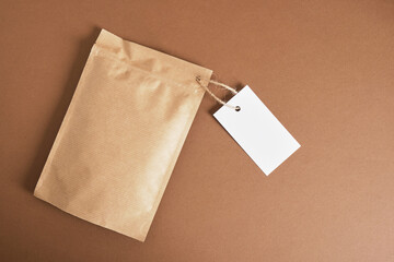 zip craft packaging with white blank mock up tag on brown background