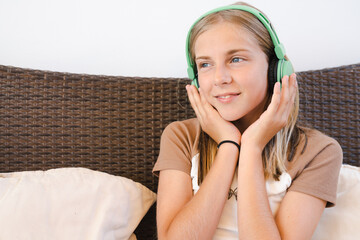 Pleasant time. Child headphones listen to music. Audiobook concept. Studying audio lessons. Girl wearing headphones listening to music