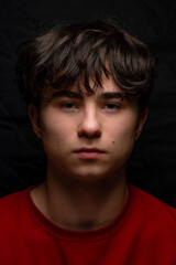 Adrian, Beautiful handsom young man wearing red sweater, Closeup portrait of young man above black background, Attractive teenager. caucasian