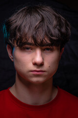 Adrian, Beautiful handsom young man wearing red sweater, Closeup portrait of young man above black background, Attractive teenager. caucasian