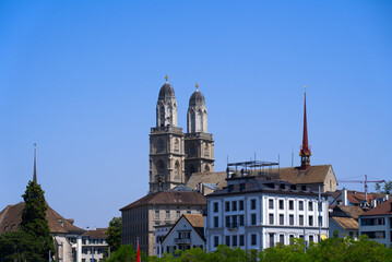 Fototapeta premium Medieval old town of Zürich with church towers of Great Minster on a sunny hot summer day. Photo taken June 19th, 2022, Zurich, Switzerland.