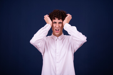 Naklejka premium Funny emotions of an attractive guy. Blue background.