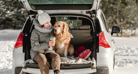 Golden retriever dog with girl in winter time