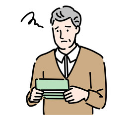 通帳を見て悩んでいるシニアの男性