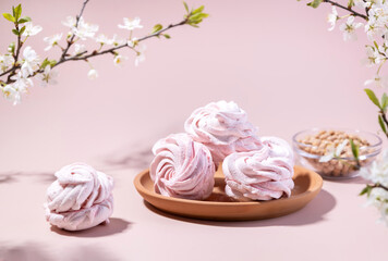 Vegan meringue, boiled chickpeas, aquafaba and plum blossom branches. The concept of vegan cuisine. A useful product. Selective focus.