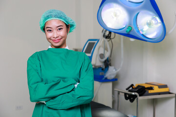 Portrait of Asian woman Surgical doctor arms crossed standing in Operating Theater ward at modern medical center.