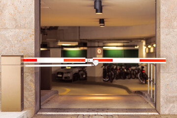Entrance Gate to underground garage parking. Automobile parking inside. Automatic barrier in...