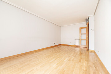 Empty living room with oak parquet and wooden doors of the same material