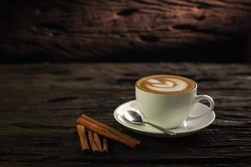 Foto op Plexiglas Koffiebar Cup of coffee latte and coffee beans in burlap sack on old wooden background