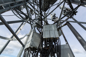 Telecommunication tower with microwave equipment, radio panel antennas, outdoor remote radio units,...