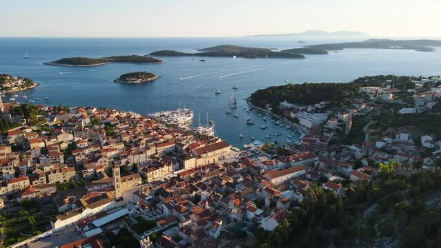 Old town Hvar with port in Adriatic sea and Paklinski islands, Dalmatia, Croatia. Aerial drone 4k video. Summer vacation destination