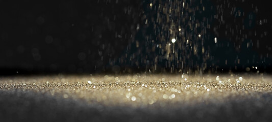 Silver Glitter Twinkling on a Surface Lit by a Bright Spotlight on Black Background with Copy Space 