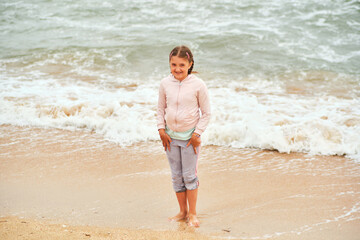 Happy child playing in the sea.