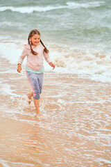 Happy child playing in the sea.