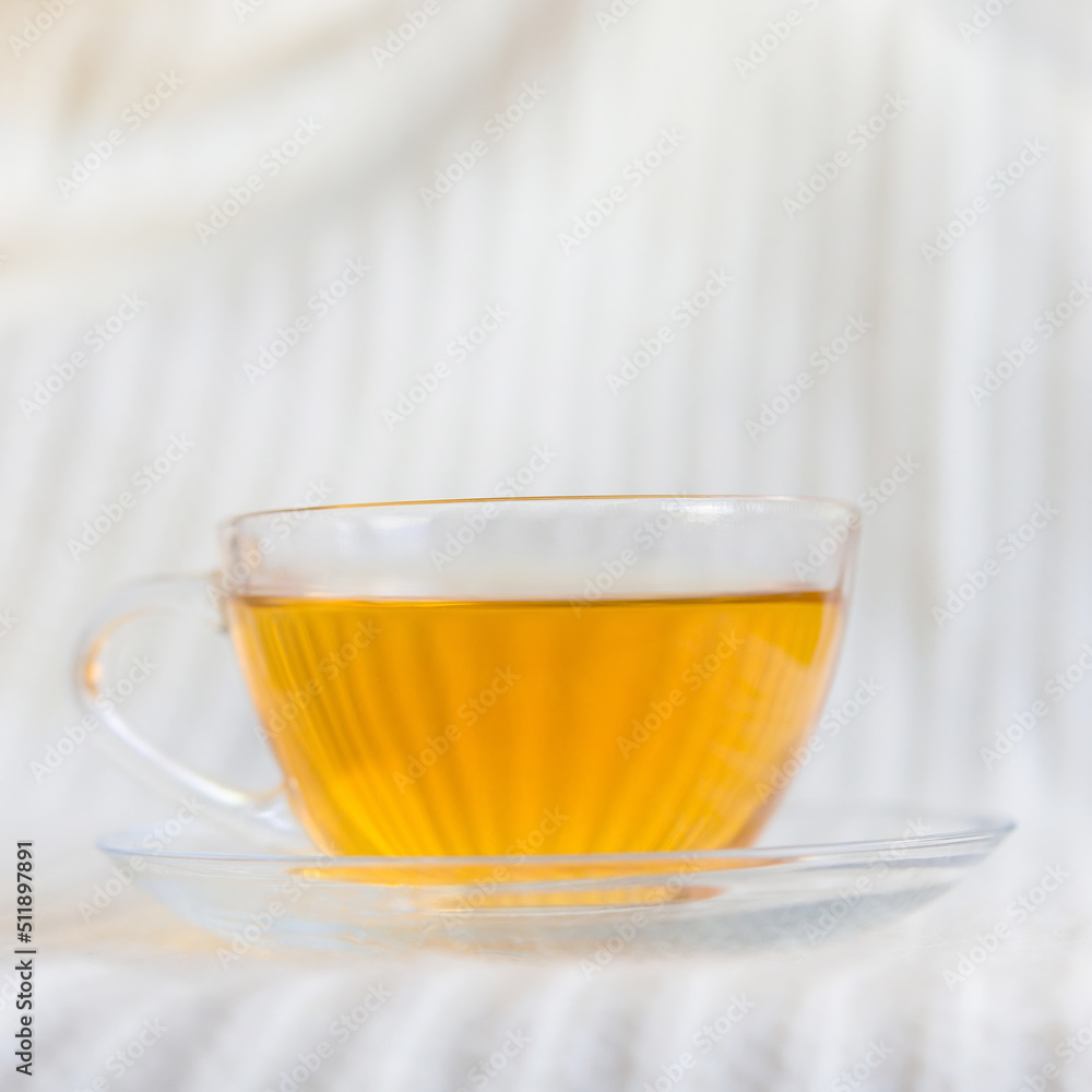 Poster close-up of hot tea with a glass cup on a light background