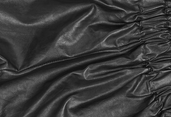 Texture of black leather material with folds. background for designers