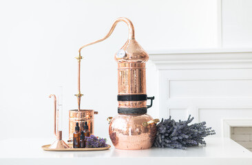 Distillation of lavender essential oil. Copper alambic in a Scandinavian interior. Chemical...