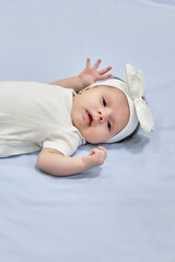Baby Girl with white Flower Headband. 2-month-old baby girl.