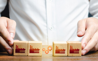 Businessman arranges work between factory productions. Industrial conglomerates and economic...
