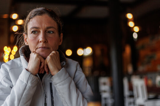 Woman Deep In Thought Sitting In A Coffee Shop