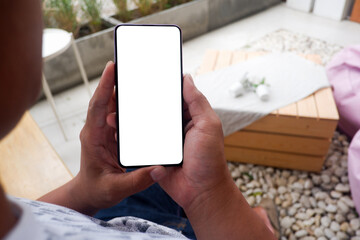 Mockup picture of business woman’s hands holding smart phone with white blank screen in modern place