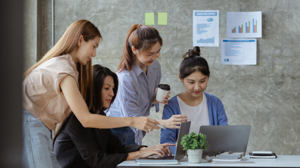 A group of young Asian business women stand and talk. Jointly open a startup company and a business plan management plan to grow the business and be profitable by the concept of the new generation.