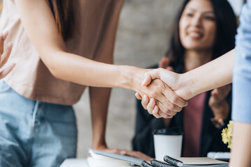 Fototapeta premium Close-up two business men holding hands, Two businessmen are agreeing on business together and shaking hands after a successful negotiation. Handshaking is a Western greeting or congratulation.