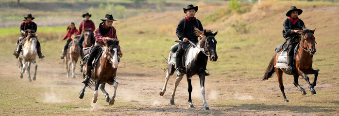 Group of cowboy and cowgirl ride horse on road with high speed near water reservoir with day light.