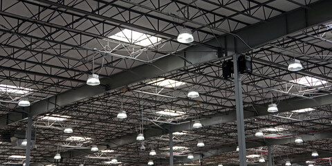 Large warehouse ceiling with skylights and electric lighting