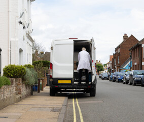 Van illegally parked on a double yellow line and obstructing the pavement for pedestrians.