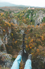 Man's legs in front of the autumnal hill in Slovenia