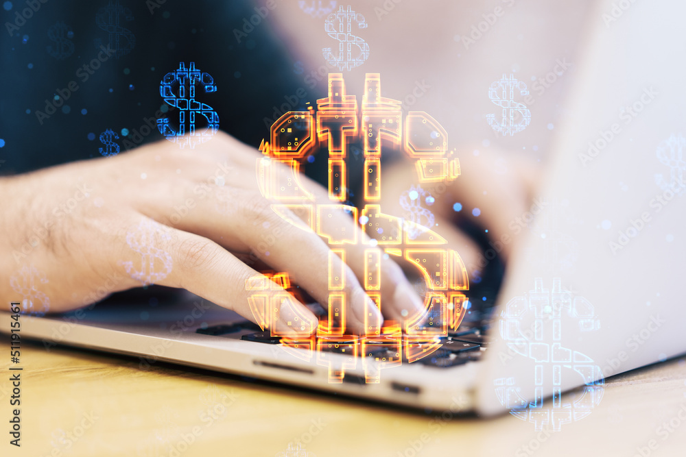 Poster close up of businessman hands using laptop keyboard with abstract glowing dollar sign hologram on bl