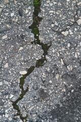 Stone wall with deep cracks. Break in the ground. Drought and consequences.