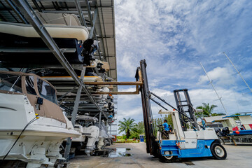 Forklift loading speedboats in a garage system in the marina © romaset