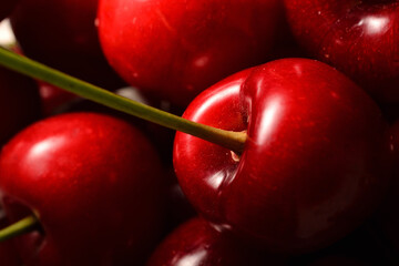 Sweet cherry and its stem in low light. Selective focus.