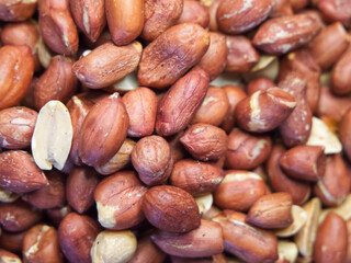 Roasted unpeeled peanuts macro, peanuts as a background