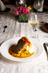 Grilled fish, mashed potatoes, passion fruit sauce, wine