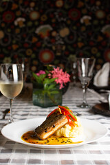 Grilled fish, mashed potatoes, passion fruit sauce, wine