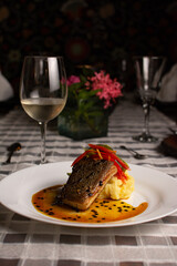 Grilled fish, mashed potatoes, passion fruit sauce, wine