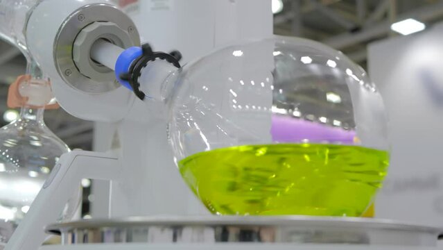 Laboratory rotary evaporator - homogenization process - rotating chemical flask for evaporate solvent from liquid at pharmacy factory, exhibition: close up. Pharma, chemistry and science concept