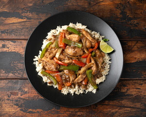 Stir fry pepper chicken with sweet peppers, onion, garlic and ginger