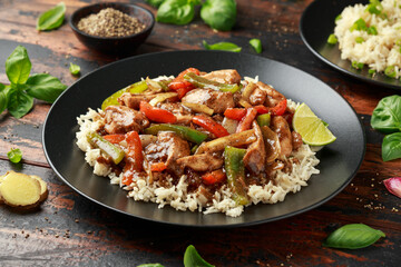 Stir fry pepper chicken with sweet peppers, onion, garlic and ginger