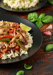 Stir fry pepper chicken with sweet peppers, onion, garlic and ginger