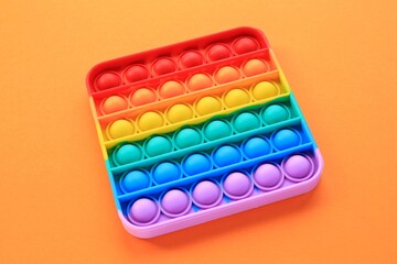 Pop it silicone rubber push antistress fidget toy. Sensory relief game for autism. Trendy popular hype poppit. Rainbow shape. Therapy, education, motor skills for childs and adults. Top view, flat lay