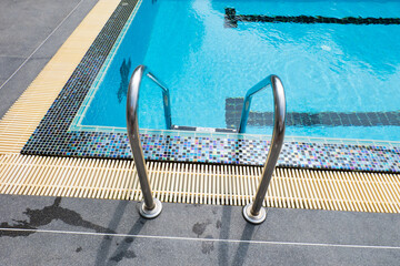 Empty Swimming pool with stair in summer.