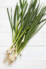 Fresh Green onions with roots. Flat lay.