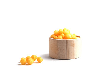 puffed ball cheese corn chips in a wooden bowl isolated on white background